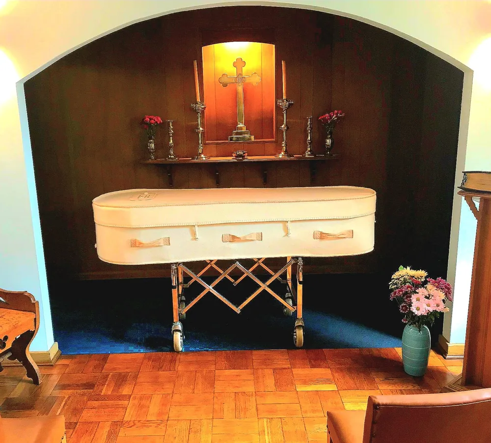 Cream fabric-covered coffin